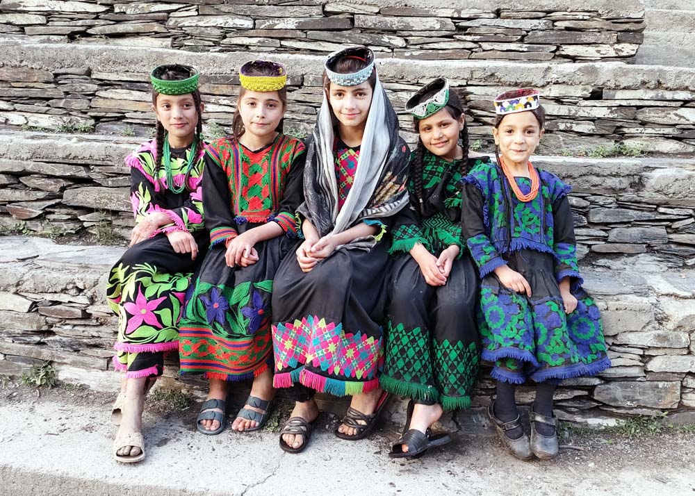 February 2025 – Kalash Girls from the Bumburet Valley, Chitral District of Khyber-Pakhtunkhwa, Pakistan, by Rosemary J. Brown.